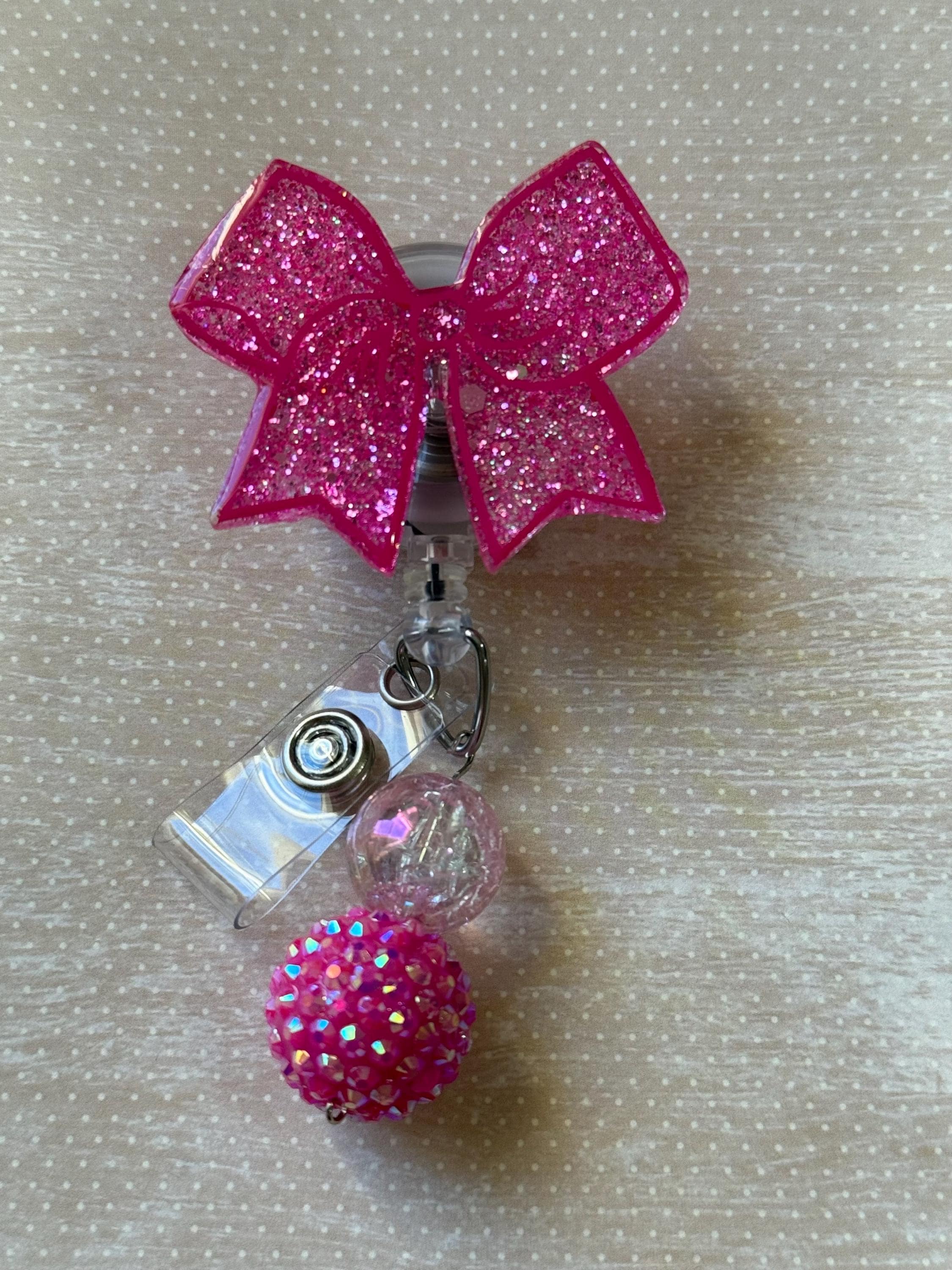 Bow badge reel swivel clip pink with beads