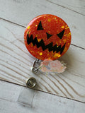 Scary pumpkin Halloween badge reel orange face